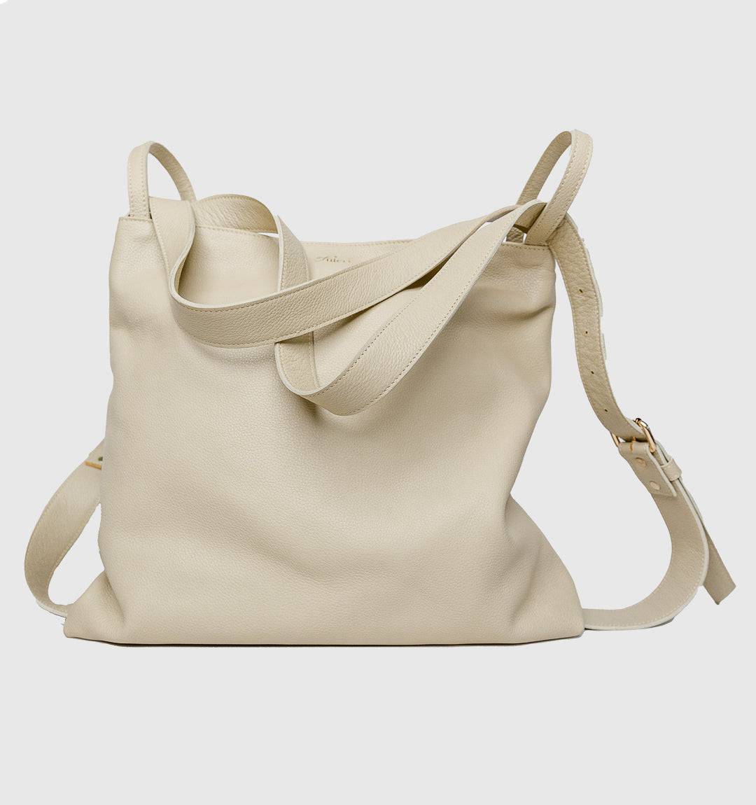 AMARA Convertible Leather Tote Beige, effortlessly transitions from tote to backpack with lightweight design and a zippered closure for security.