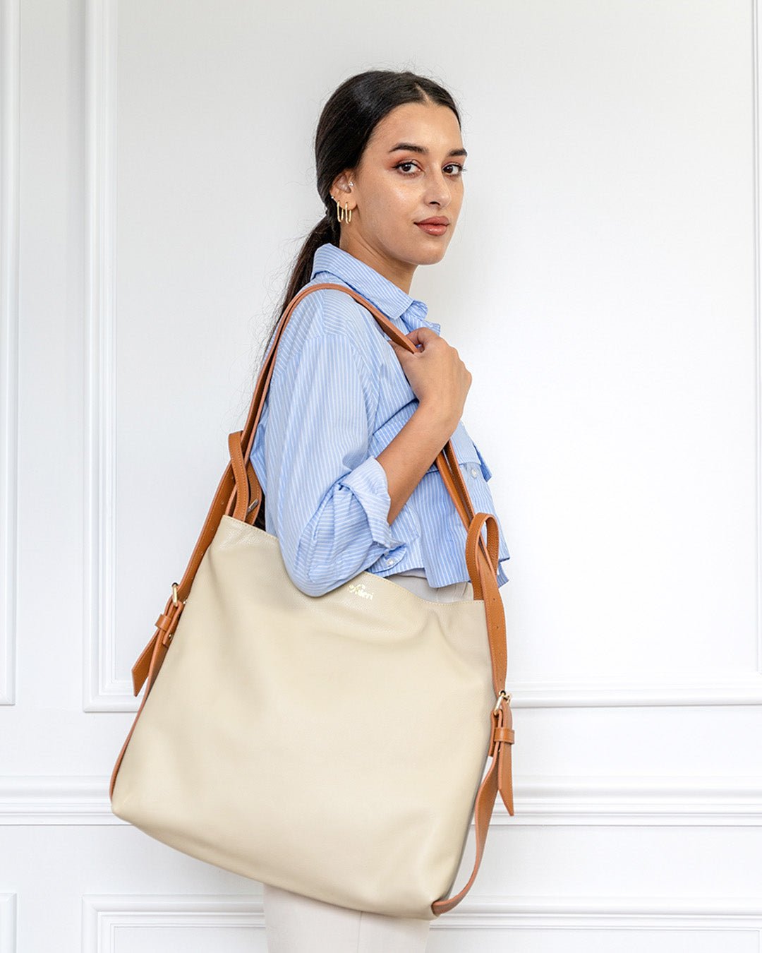 FULERI AMARA Dual Convertible Leather Tote Bag in Dune Beige, worn on the shoulder and backpack