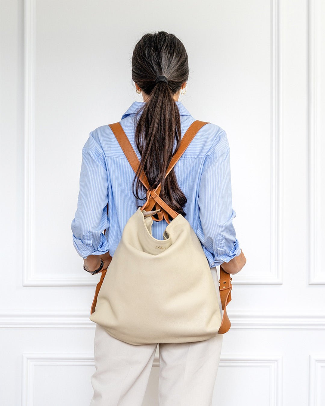 Fuleri AMARA Dual convertible leather tote bag in Dune, styled as a backpack and shoulder bag.