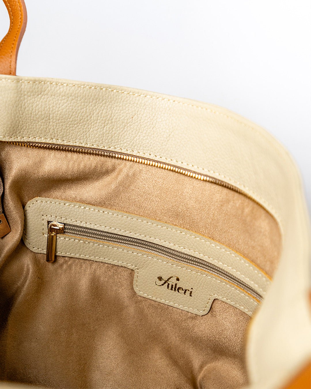 Inside view of the FULERI Convertible AMARA Dual Tote Bag in Dune Beige, featuring a lined interior, multiple compartments, and a zippered pocket