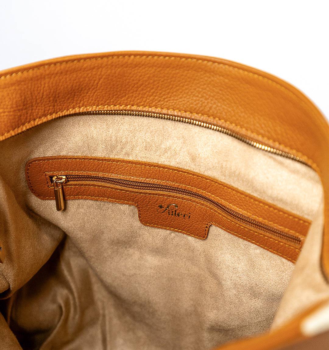 Inside view of the FULERI Convertible AMARA Dual Tote Bag in Sandstone Tan, featuring a lined interior, secure zippered pocket, and two compartments for organized storage