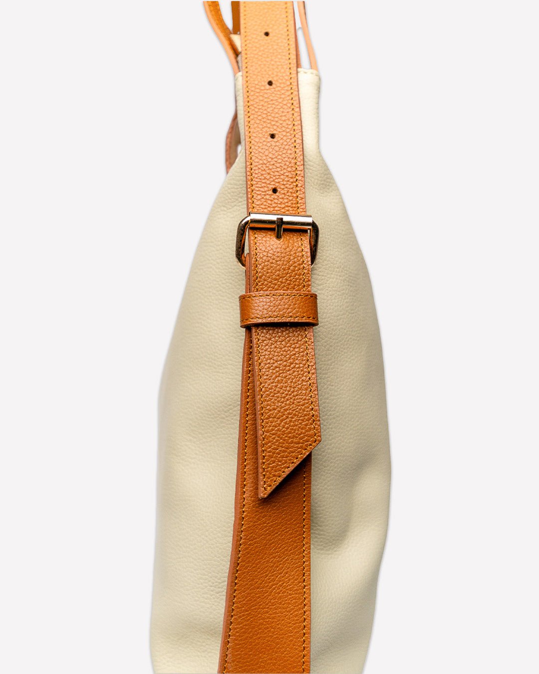 Side view of the FULERI Convertible AMARA Dual Tote Bag in Dune Beige, showcasing the adjustable leather strap and two-tone premium leather craftsmanship.